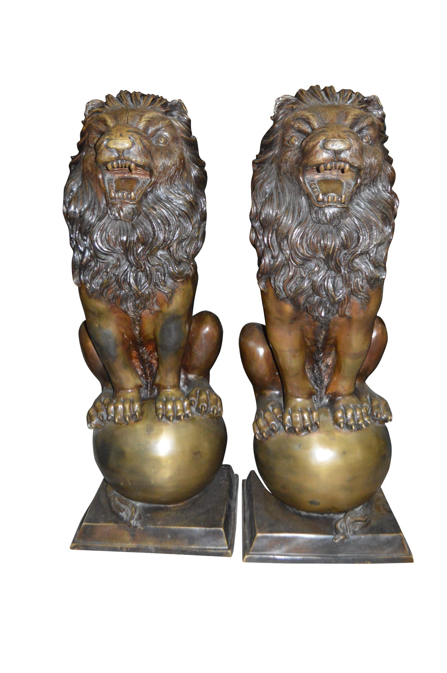 Pair of lions standing on balls, bronze statues - Size: 14"L x 16"W x 38"H.