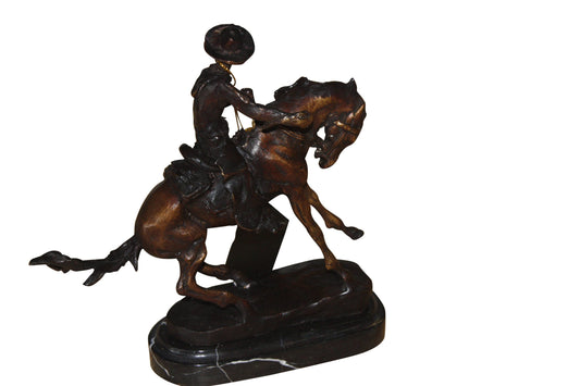 Remington Cowboy on marble Bronze Statue - Size: 10"L x 3.5"W x 10"H.