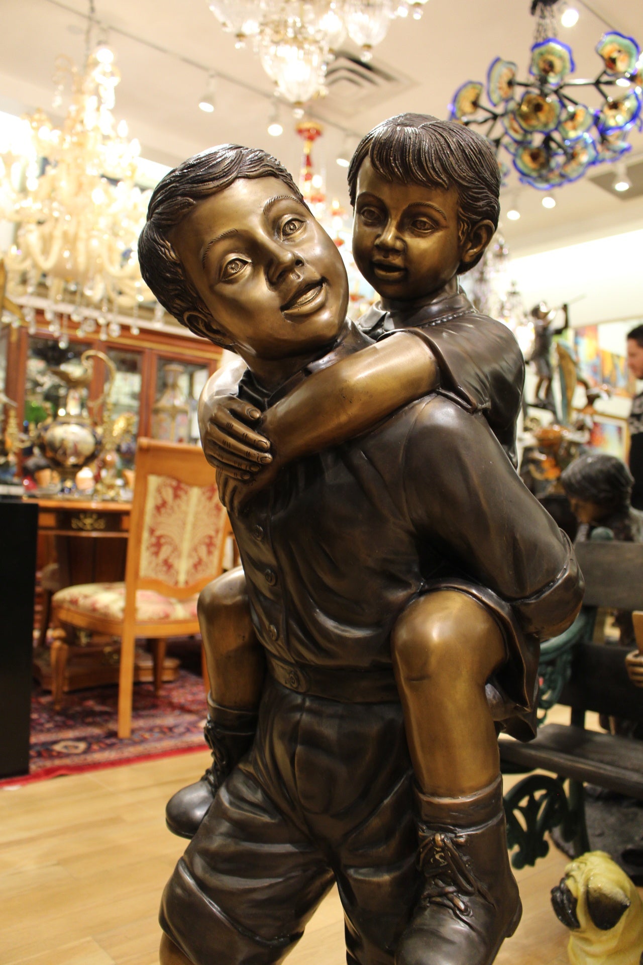 Boy Giving Girl Piggyback Ride Bronze Statue - Size: 23"L x 16"W x 46"H.