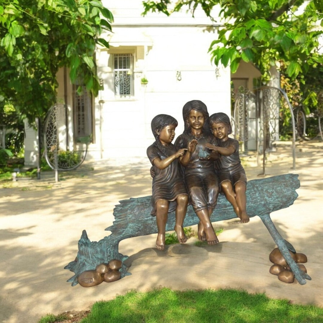 Three Children On Log Holding Bird Bronze Statue - Size: 55"L x 18"W x 38"H.