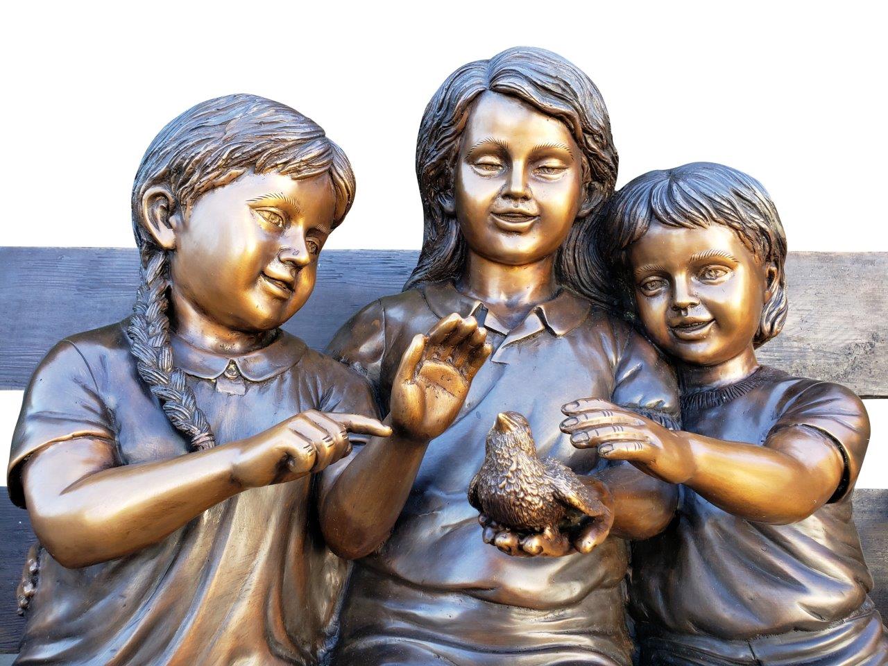 Three kids on a Bench Holding a Bird Bronze Statue - Size: 40"L x 30"W x 33"H.