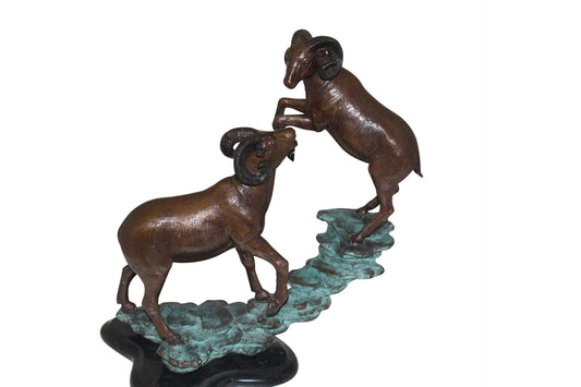 Two Rams on a rock Bronze Statue - Size: 15"L x 8"W x 16"H.