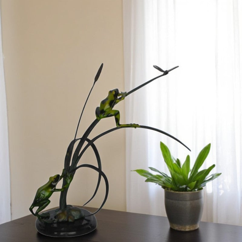 Two Green Frogs catching a dragonfly Bronze Statue - Size: 17"L x 10"W x 13"H.