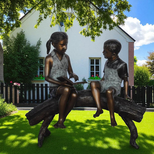 Two Kids on a tree log reading Bronze Statue Large - Size: 44"L x 17"W x 42"H.
