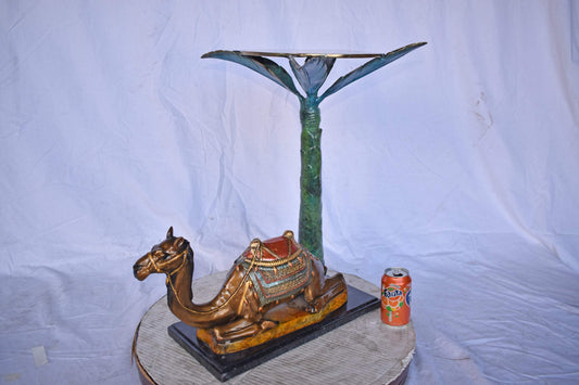 Camel Sitting Under A Palm Tree Bronze Statue - Size: 17"L x 27"W x 23"H.