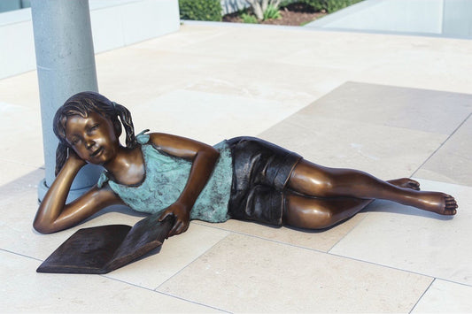 Nifao Bronze Girl Reading on Ground Statue – Hand-Cast Lost Wax Outdoor Sculpture with Book, Patina Finish - 40" L x 17" W x 13" H.