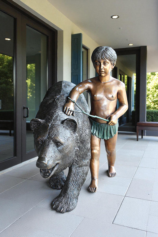 A bear with a boy bronze statue - Size: 39"L x 24"W x 32"H.
