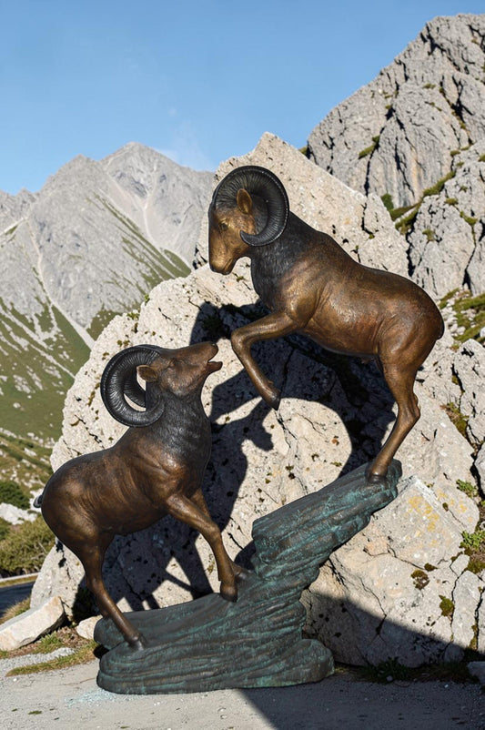 Two Life Size Rams on a rock Bronze Statue - Size: 49"L x 20"W x 64"H.