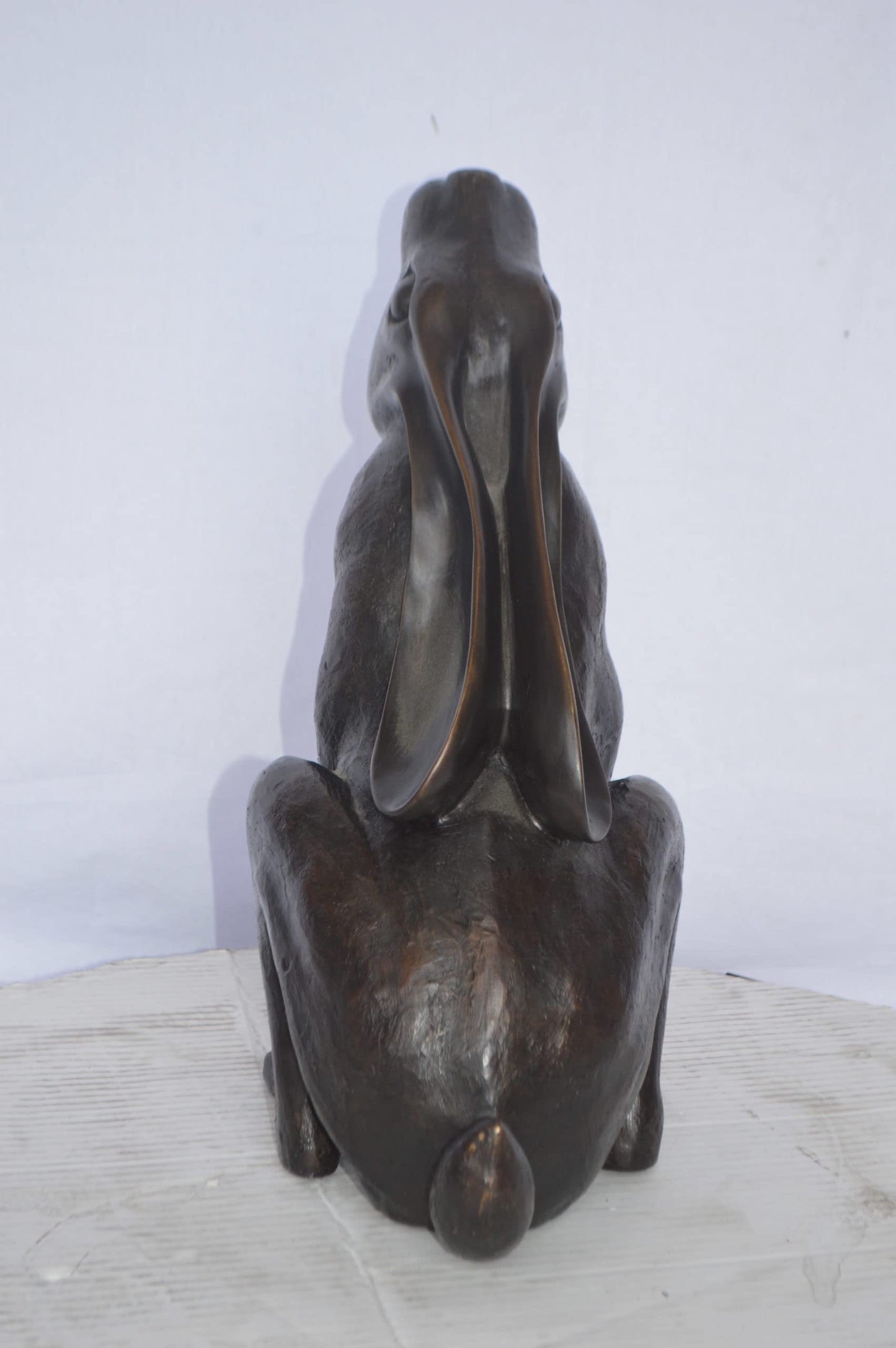 Rabbit Gazing Up Bronze Statue - Size: 8"L x 14"W x 16"H.