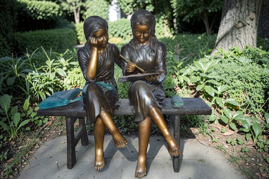 Two Schoolgirls Sitting On a Bench Bronze Statue - Size: 45"L x 24"W x 41"H.