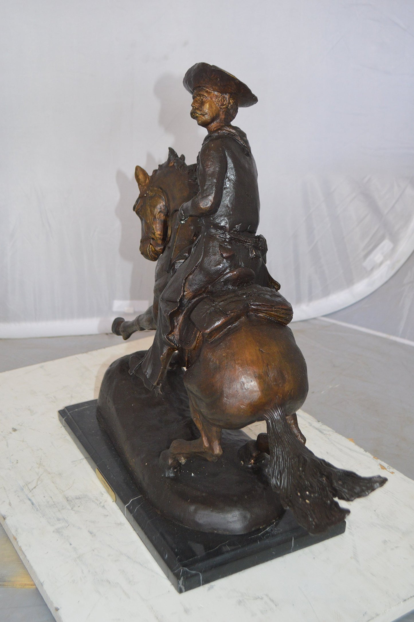 Remington Cowboy on marble Bronze Statue - Size: 24"L x 9"W x 23"H.