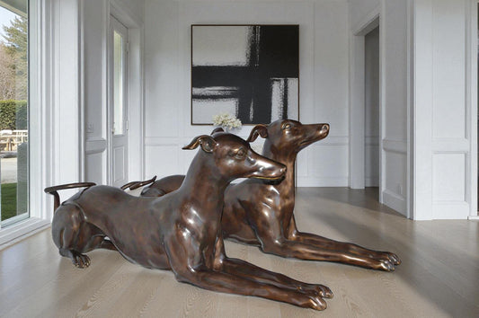 Pair of Greyhound dogs laying down Bronze Statues - Size: 50"L x 11"W x 20"H.