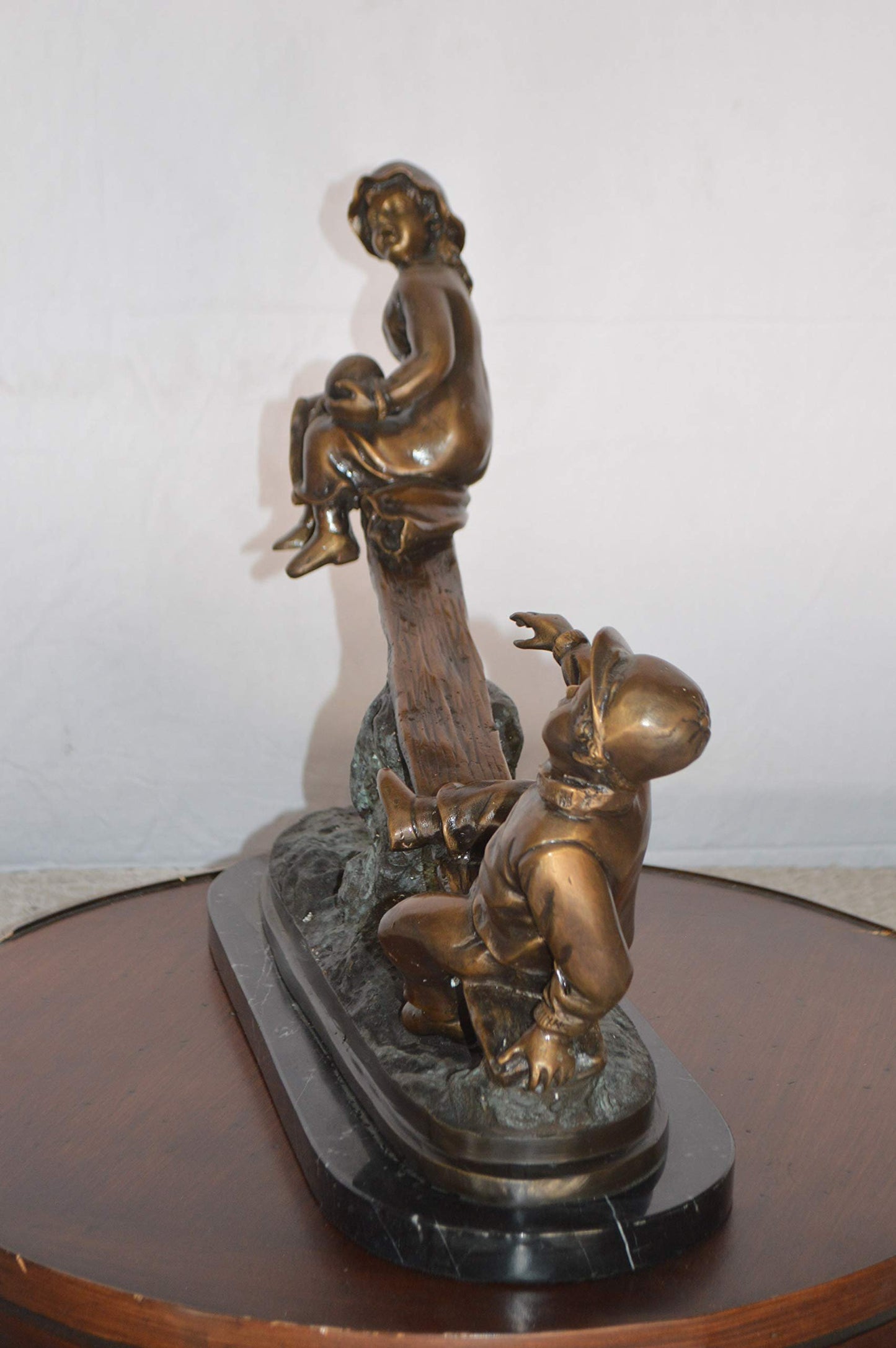 Boys Playing Seesaw on a Marble Base Bronze Statue - Size: 22"L x 8"W x 17"H.