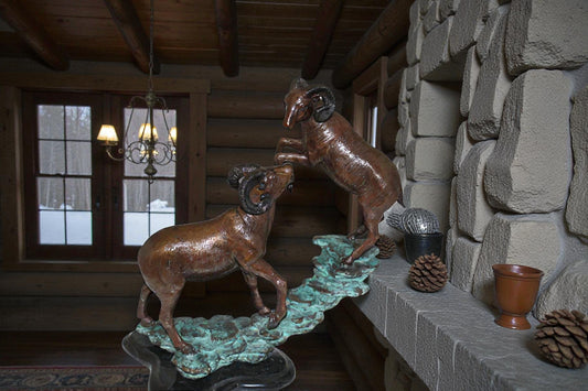 Two Rams on a rock Bronze Statue - Size: 15"L x 8"W x 16"H.