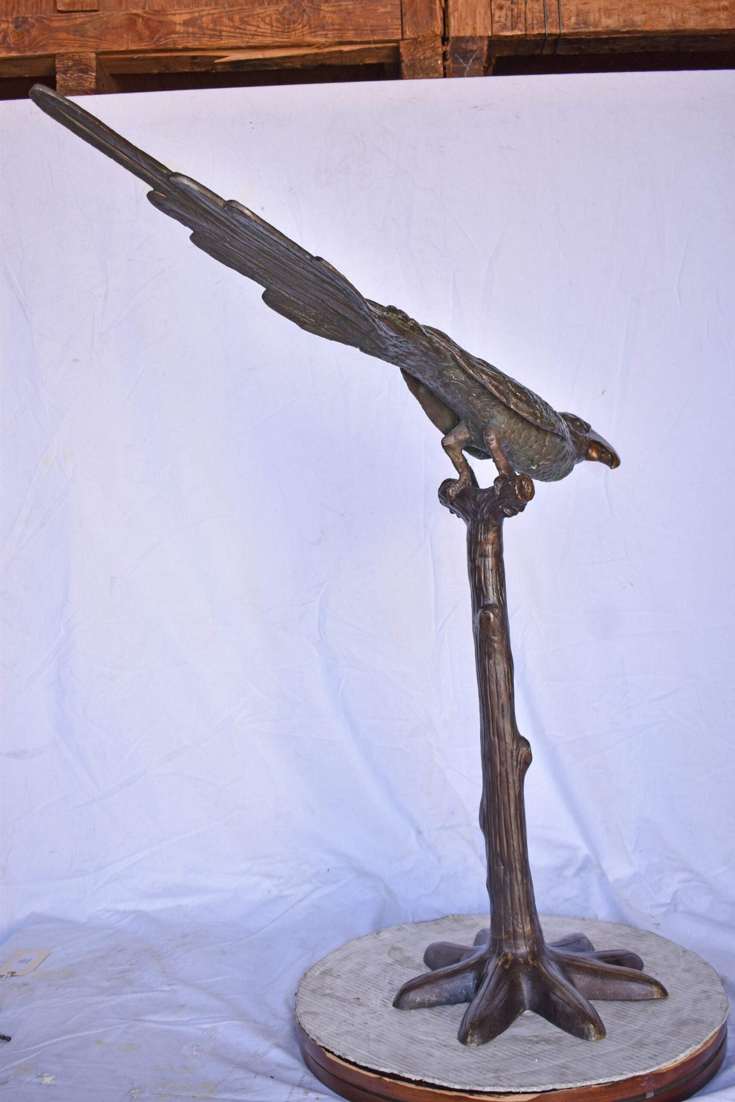 Parrot on a Tree looking Down Bronze Statue - Size: 37"L x 15"W x 47"H.