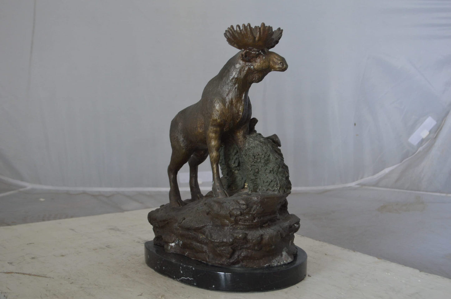 Moose on a rock bronze statue - Size: 9"L x 7"W x 14"H.