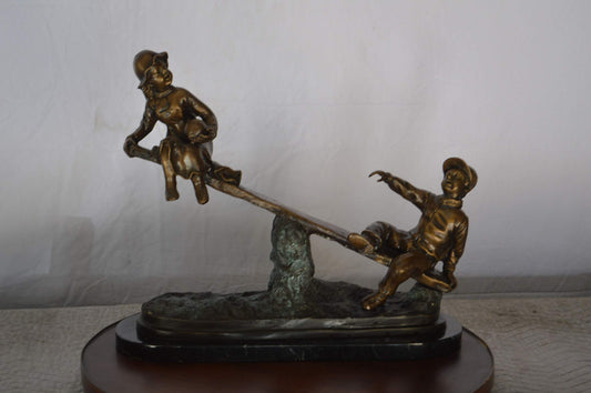 Boys Playing Seesaw on a Marble Base Bronze Statue - Size: 22"L x 8"W x 17"H.