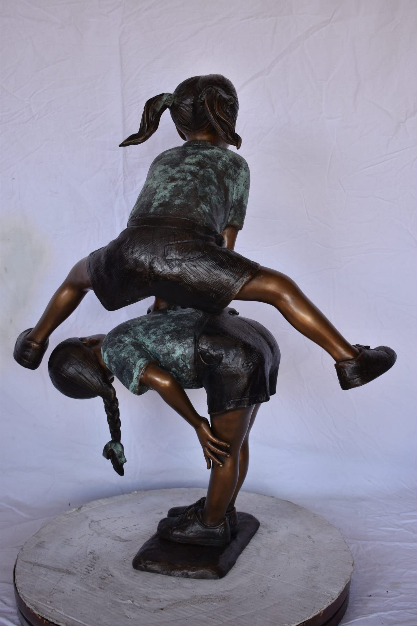 Two Girls Playing Leapfrog Jumping Bronze Statue - Size: 30"L x 14"W x 34"H.