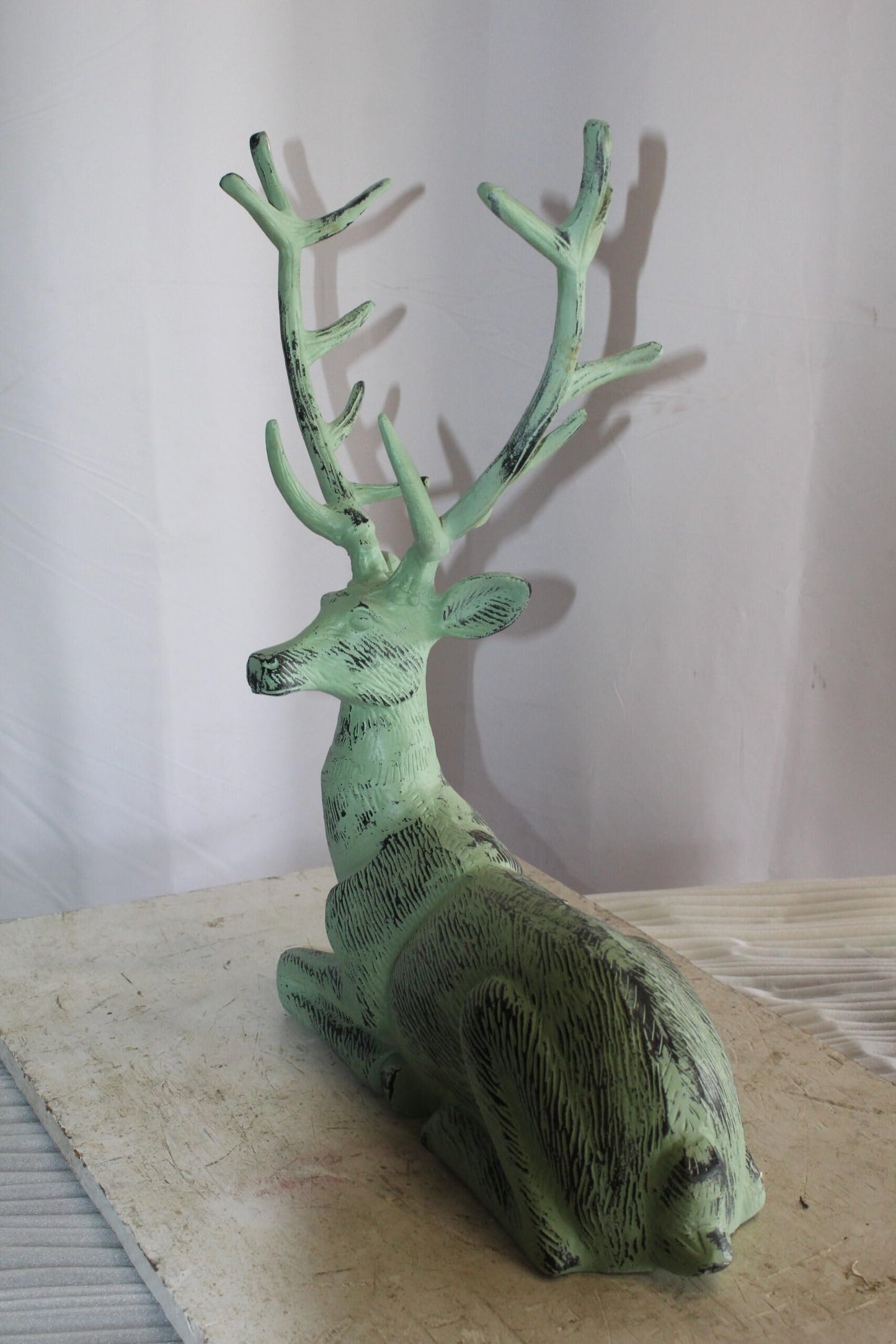 Aluminum Deer Statue Green Patina Resting on the ground 26" x 7" x 24"H