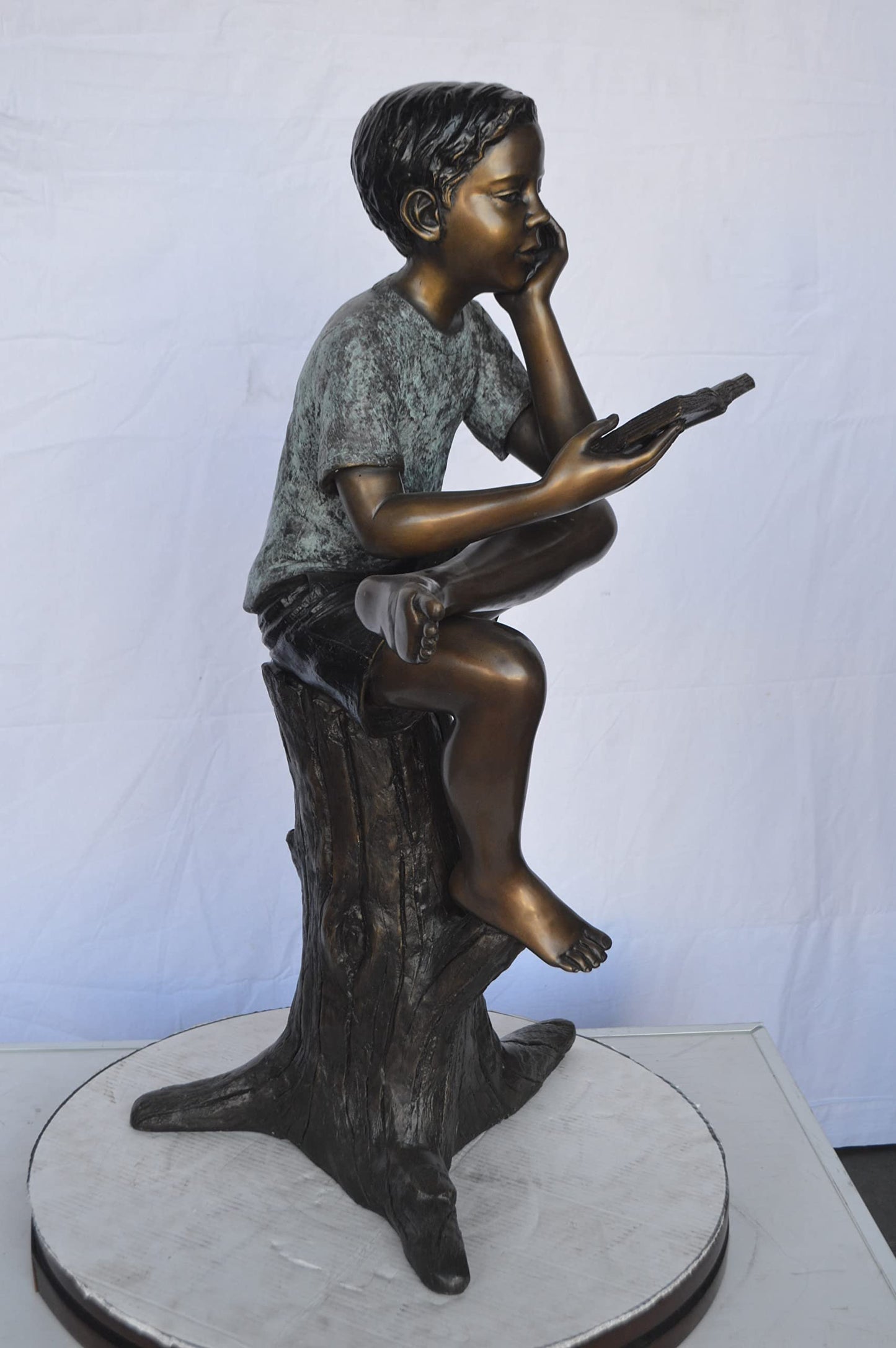 Boy Sitting on a Stump Reading a Book - Size: 18"L x 20"W x 35"H.
