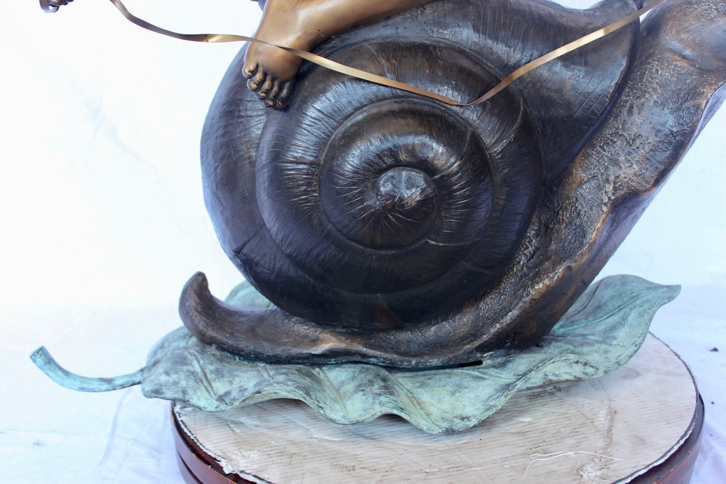 Happy boy riding a snail bronze statue fountain - Size: 42"L x 14"W x 34"H.