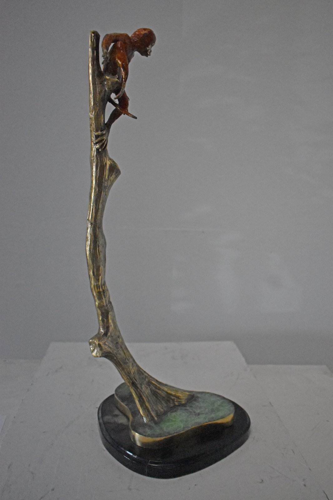 Colored Monkey Resting on a Tree Bronze Statue - Size: 12"L x 13"W x 27"H.