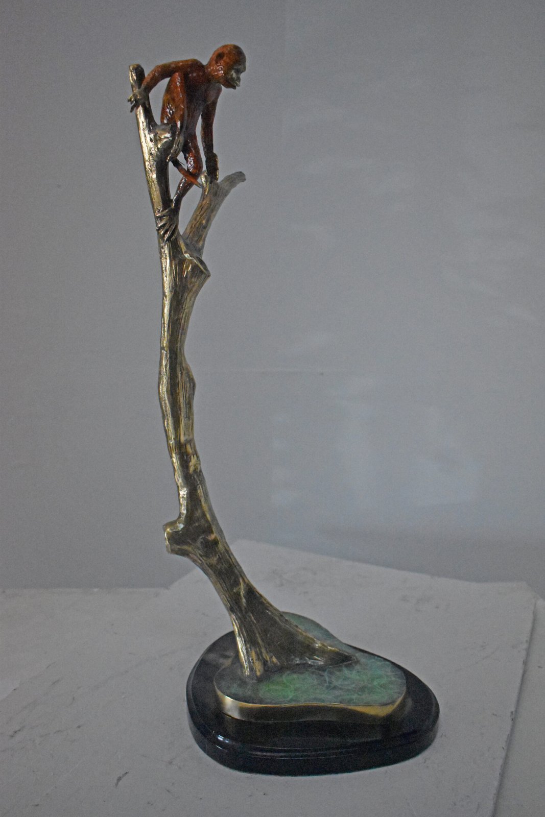 Colored Monkey Resting on a Tree Bronze Statue - Size: 12"L x 13"W x 27"H.