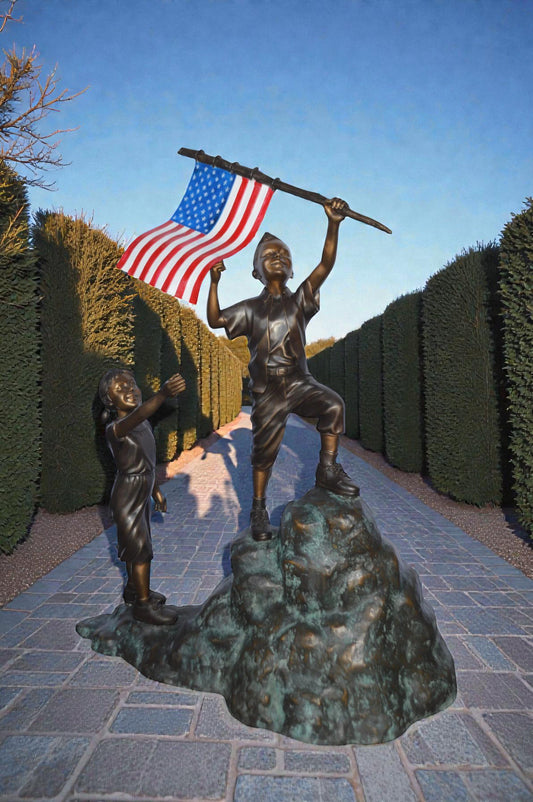 Two Kids on Rock W the American Flag Bronze Statue - Size: 50"L x 22"W x 58"H.