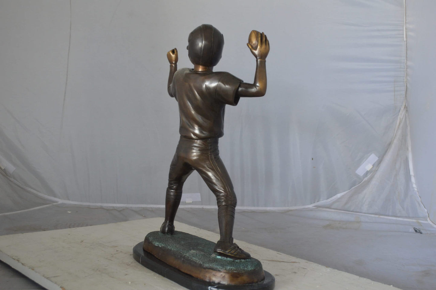 Young Quarterback bronze statue - Size: 14"L x 6"W x 20"H.