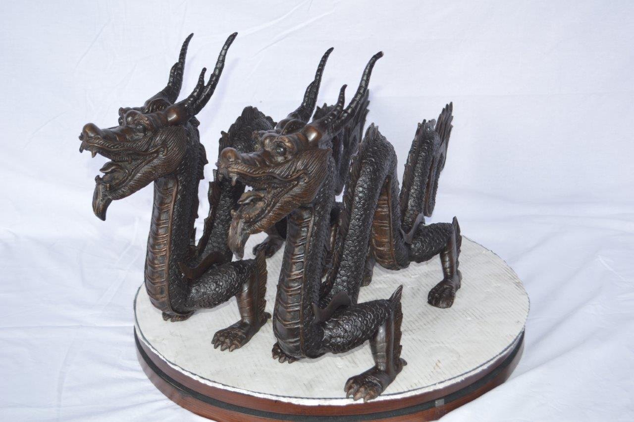 Pair of Dragons sitting side by side bronze statues - Size: 31"L x 7"W x 16"H.