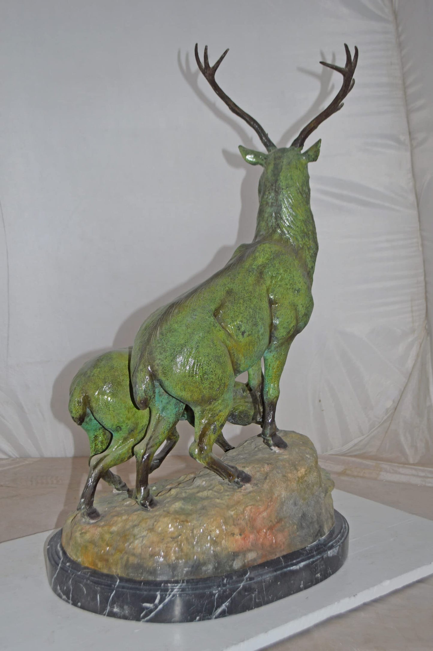 Two Deers Bronze Statue with a Green patina finish - Size: 15"L x 22"W x 32"H.