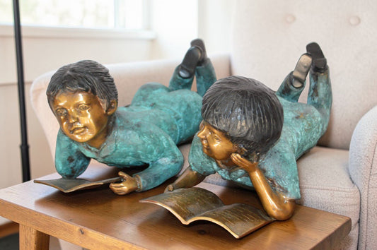 Set of a Boy and a Girl Reading a Book Bronze Statue - Size: 16"L x 7"W x 8"H.