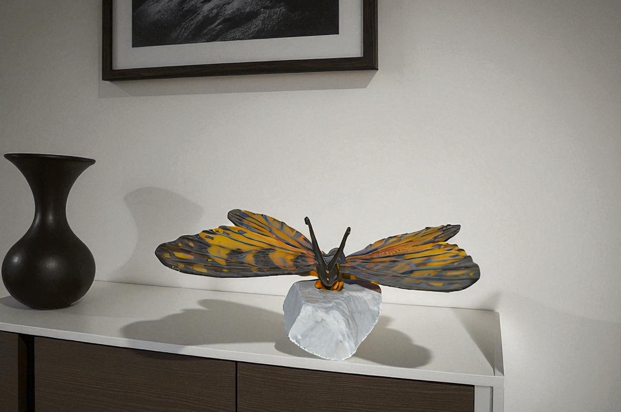 Orange Monarch butterfly bronze statue on a  rock - Size: 14"L x 16"W x 8"H.