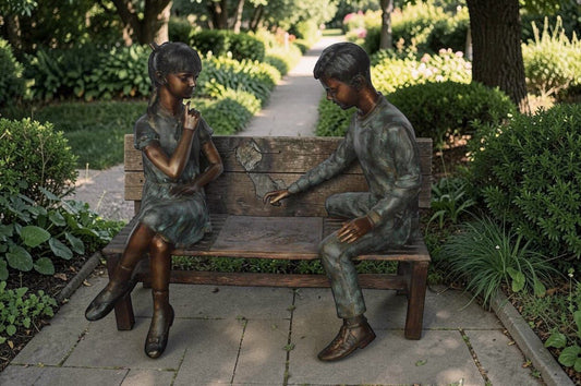 Young Couple Reviewing a World Map Bronze Statue - Size: 32"L x 47"W x 42"H.