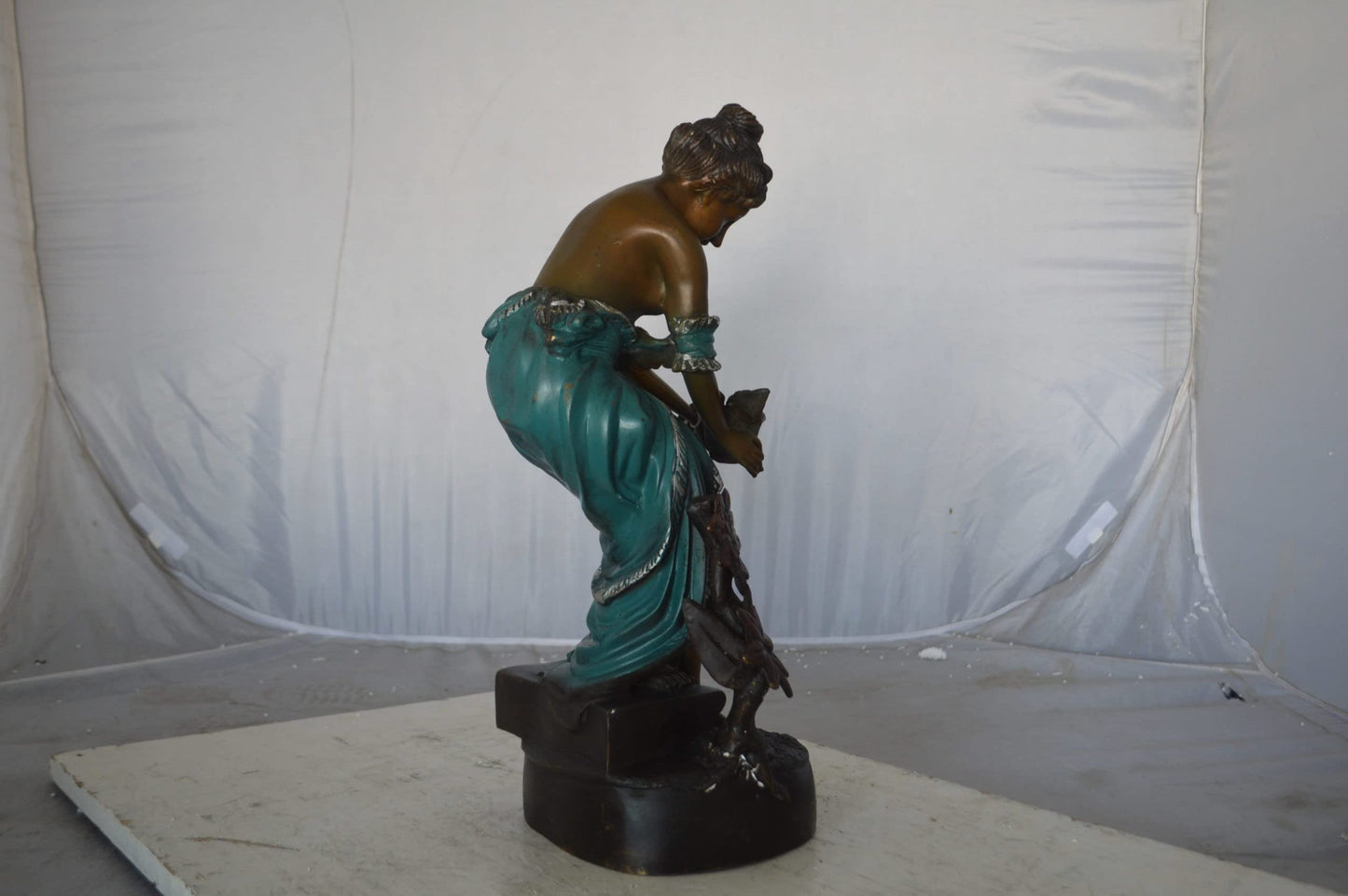 Lady holding a bird bronze statue - Size: 10"L x 9"W x 20"H.