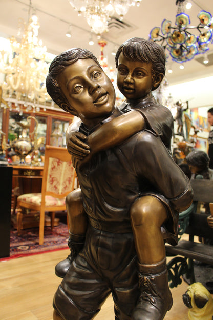 Boy Giving Girl Piggyback Ride Bronze Statue -  Size: 23"L x 16"W x 46"H. 
