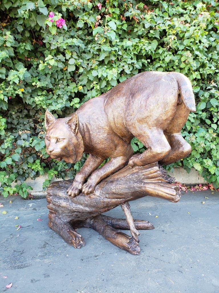 Bobcat Going Down a Tree Log Bronze Statue -  Size: 43"L x 25"W x 41"H.
