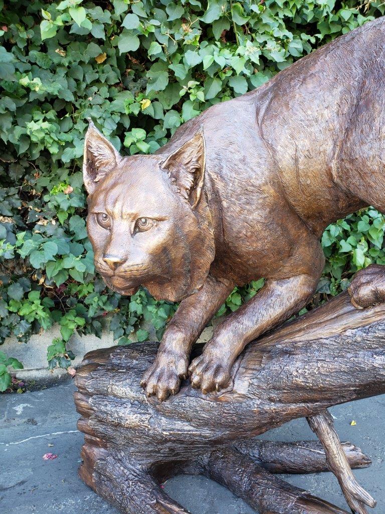 Bobcat Going Down a Tree Log Bronze Statue -  Size: 43"L x 25"W x 41"H.