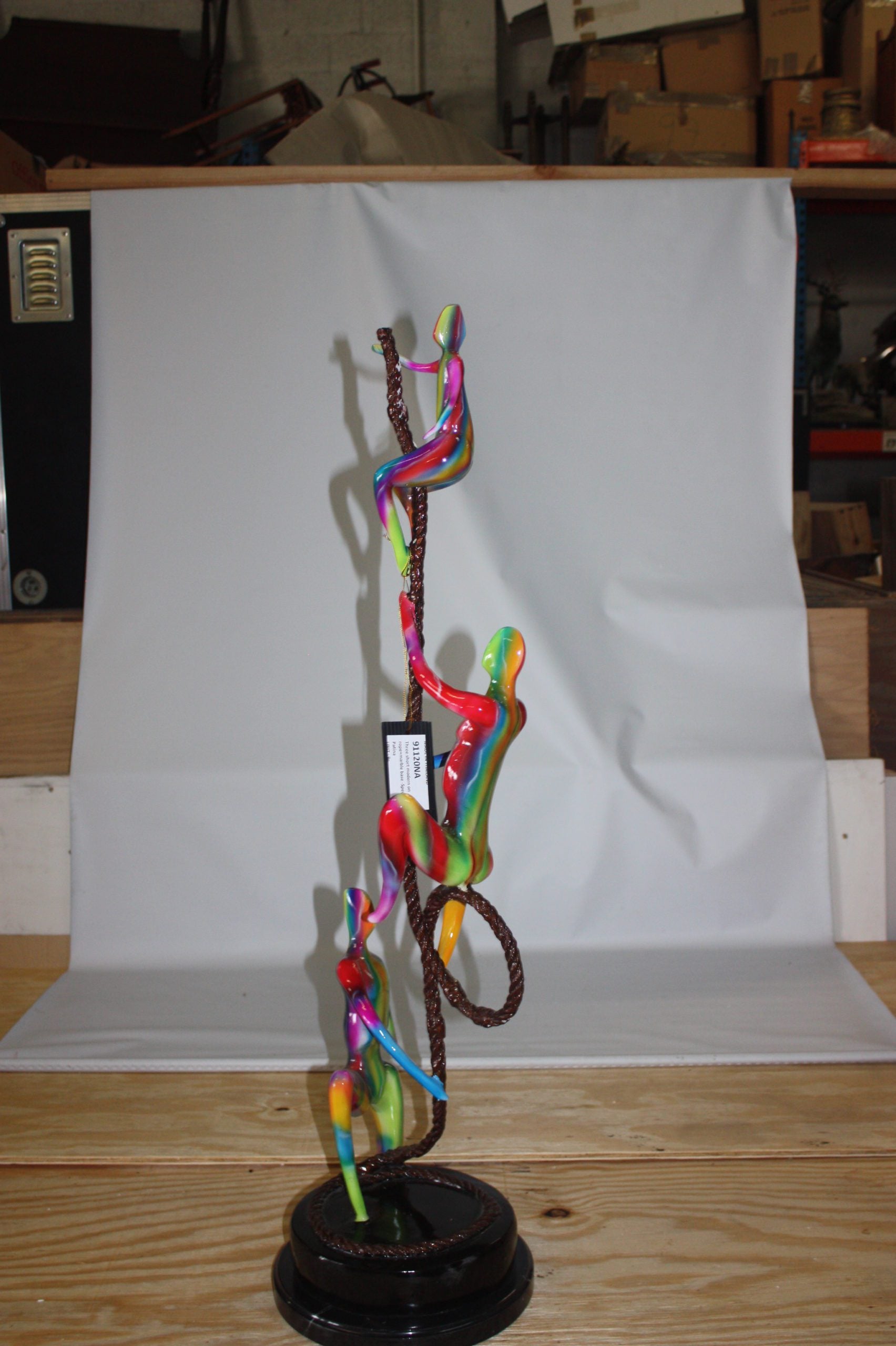 Three man made of Bronze climbing on rope -  Size: 10"L x 13"W x 37"H. 