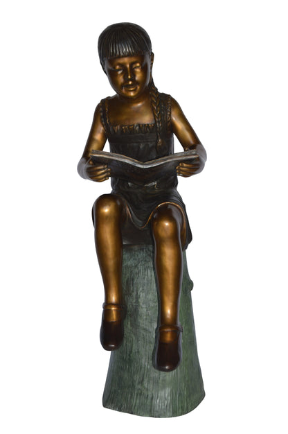 Girl Sitting on a Tree Stump, Reading Bronze Statue - Size: 15"L x 20"W x 22"H.
