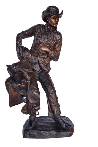Cowboy Holding His Saddle Bronze Statue - Size: 20"L x 14"W x 35"H.