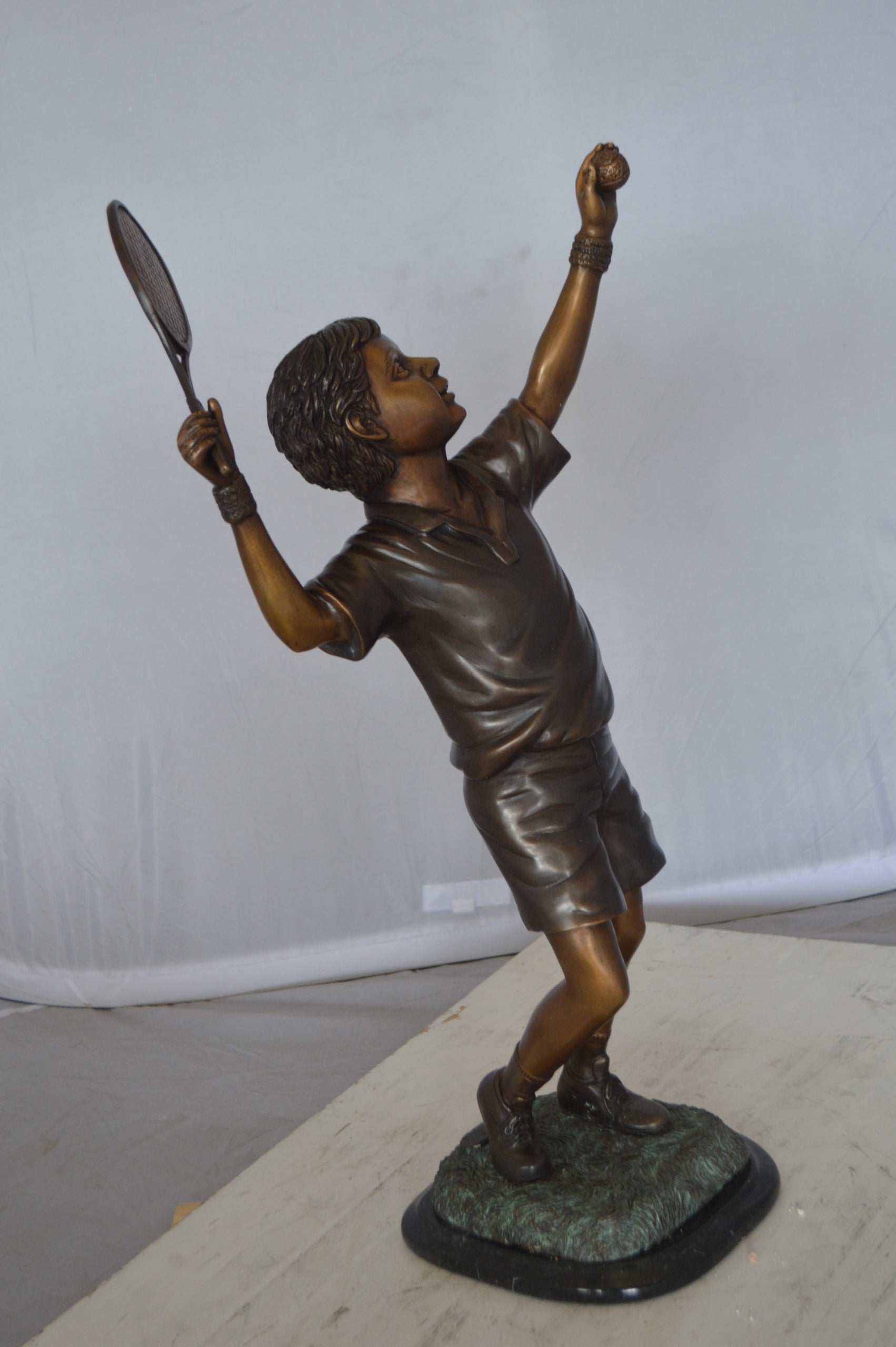 Boy Playing Tennis Bronze Statue -  Size: 12"L x 8"W x 25"H. 