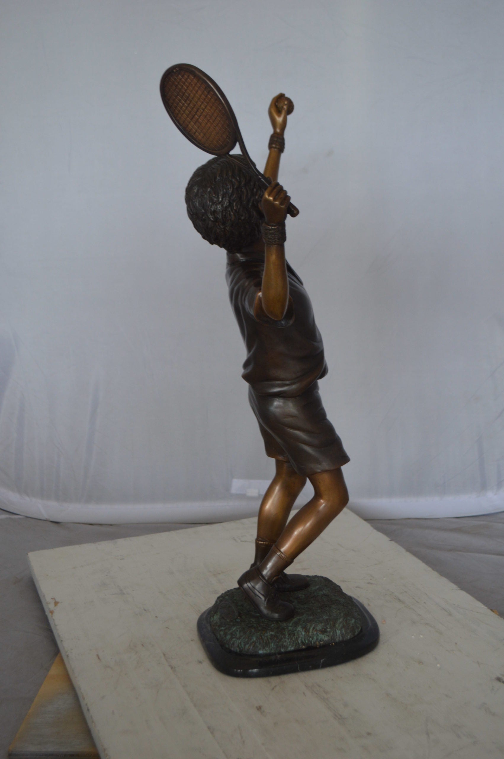 Boy Playing Tennis Bronze Statue -  Size: 12"L x 8"W x 25"H. 