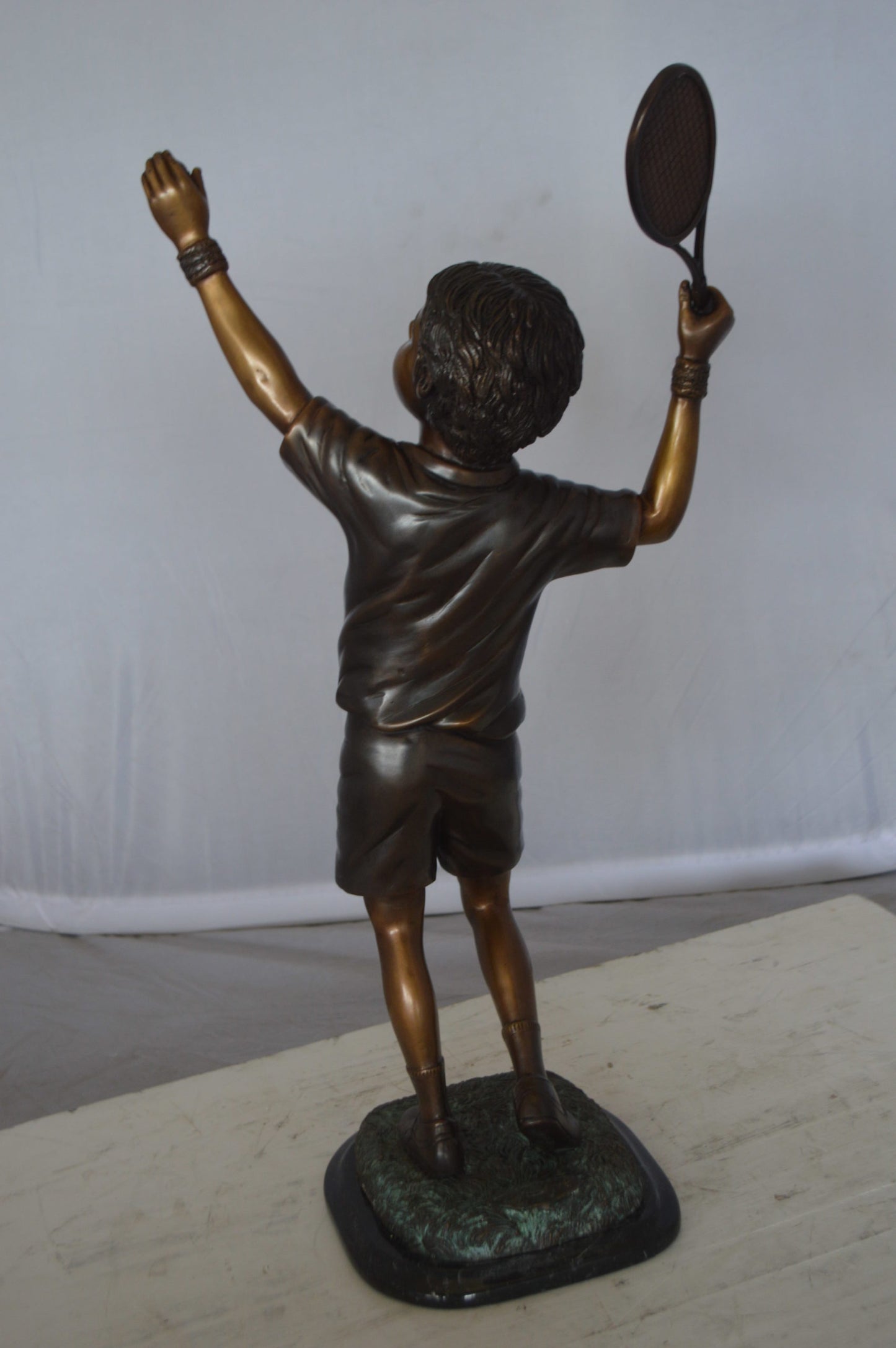 Boy Playing Tennis Bronze Statue -  Size: 12"L x 8"W x 25"H. 