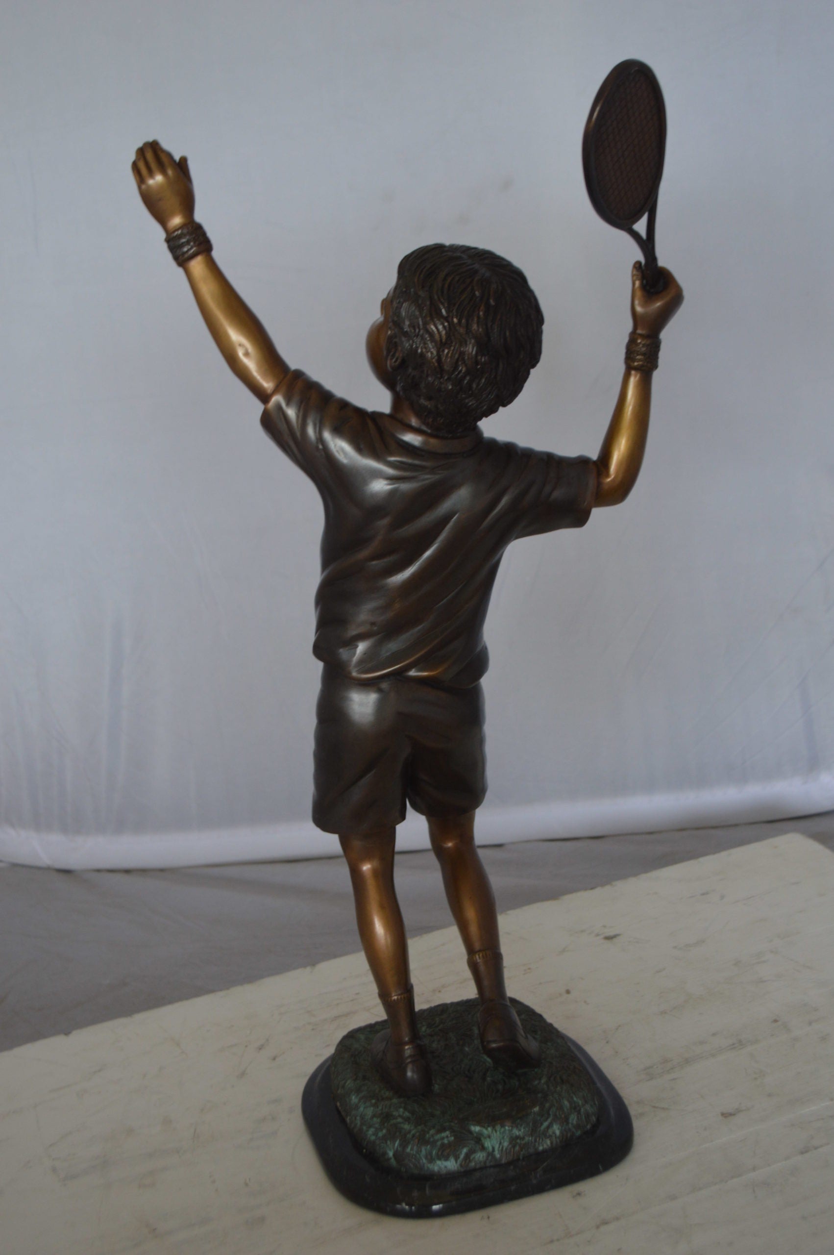 Boy Playing Tennis Bronze Statue -  Size: 12"L x 8"W x 25"H. 