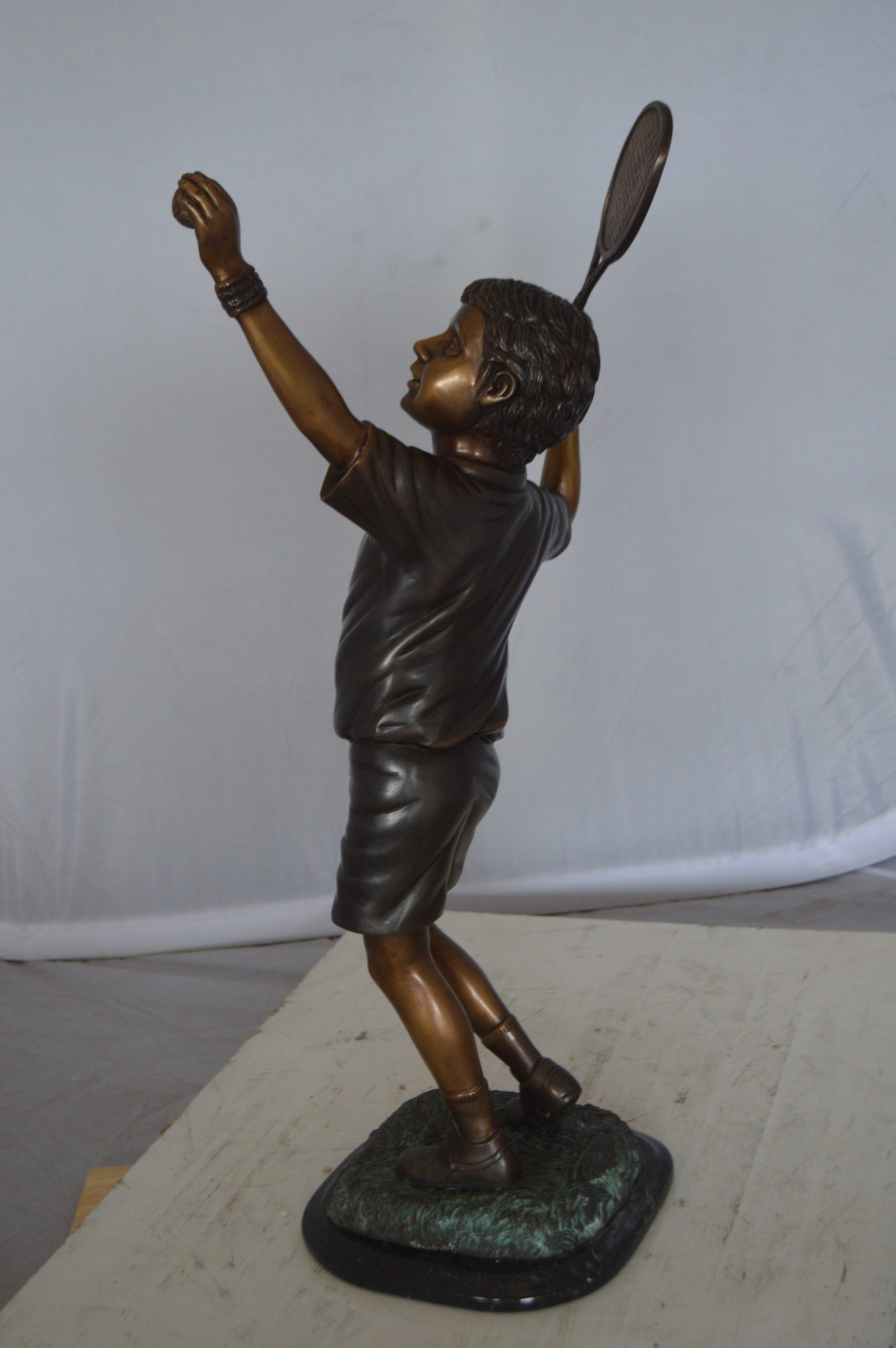 Boy Playing Tennis Bronze Statue -  Size: 12"L x 8"W x 25"H. 