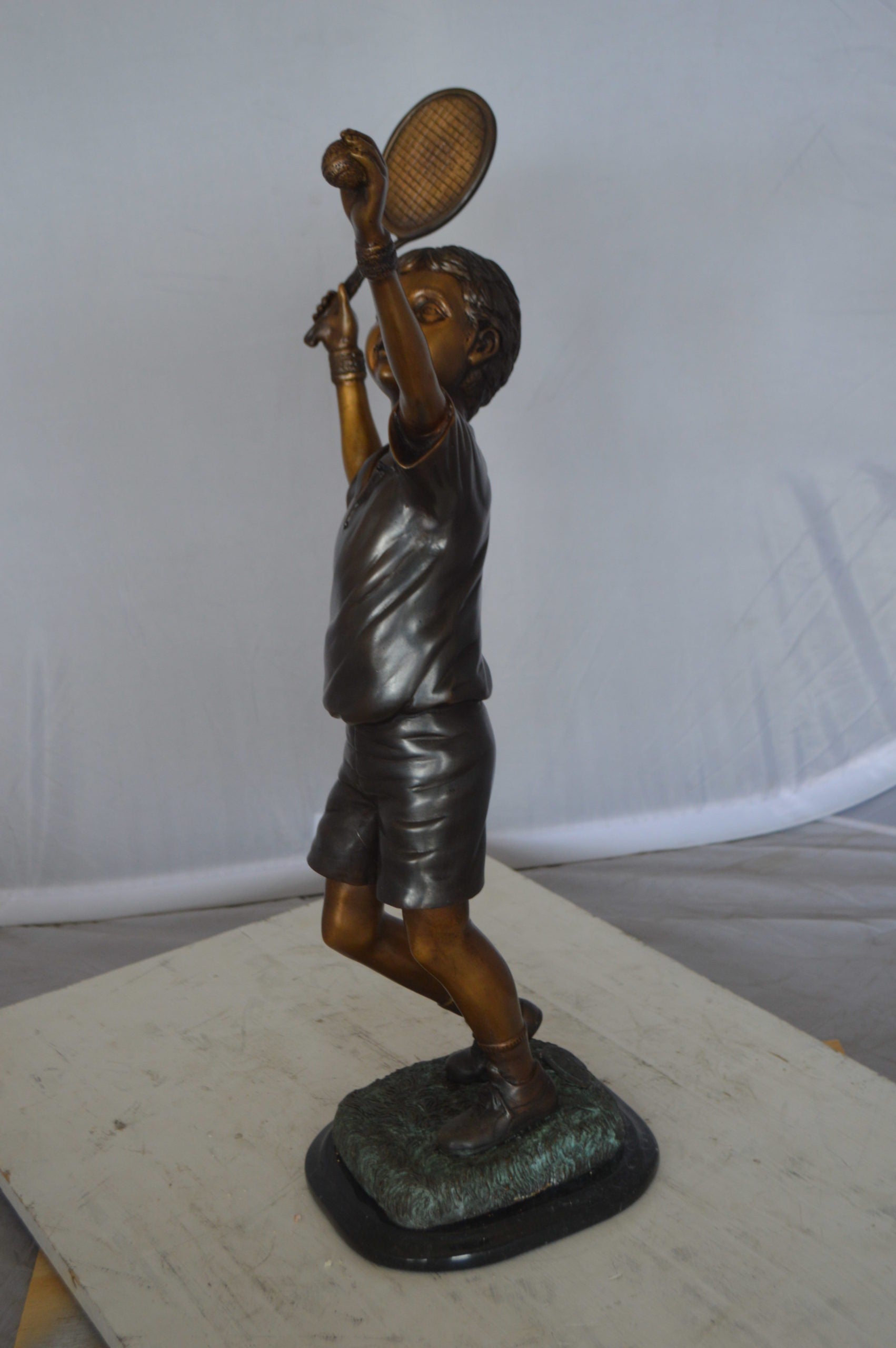Boy Playing Tennis Bronze Statue -  Size: 12"L x 8"W x 25"H. 