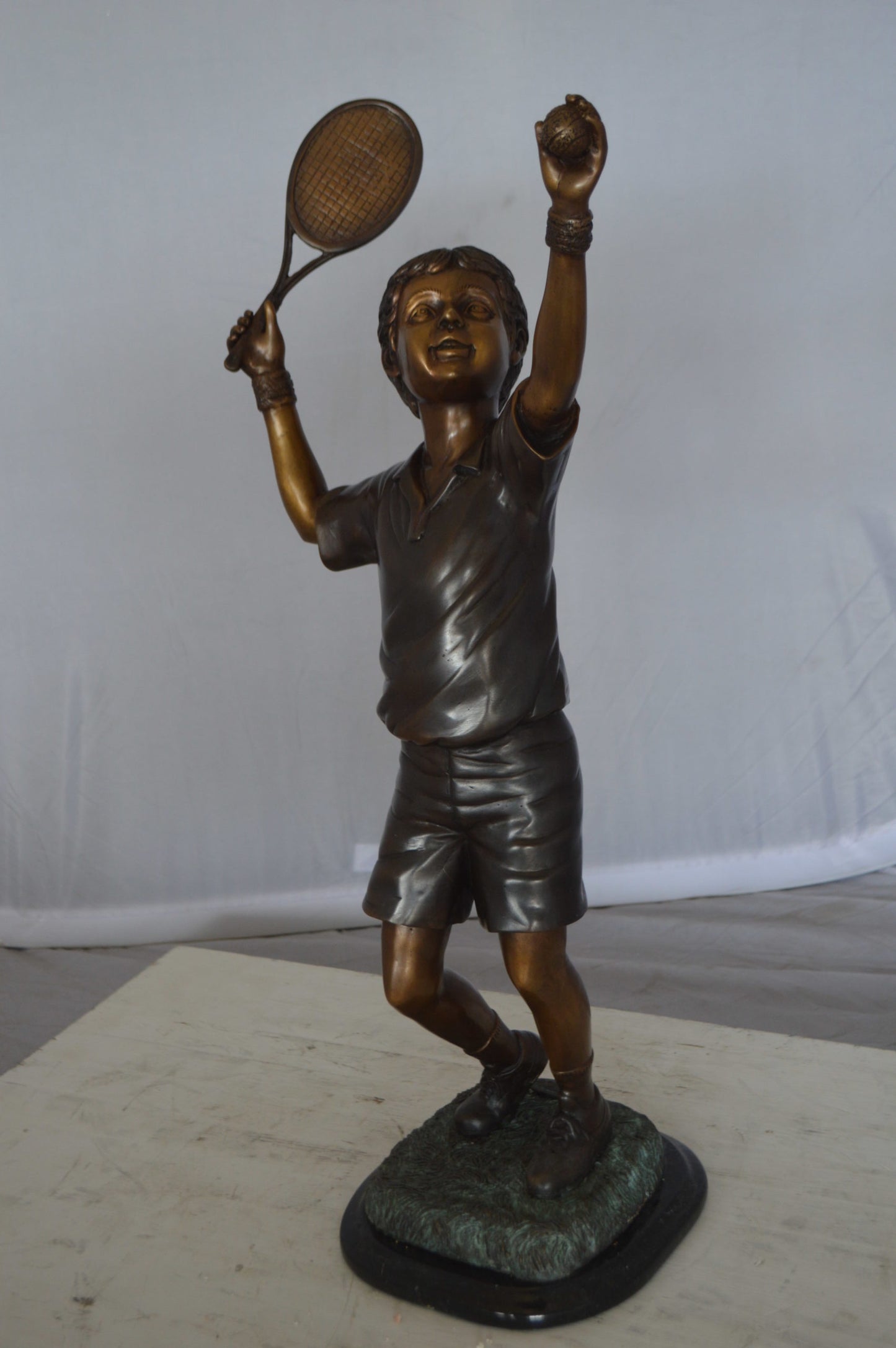 Boy Playing Tennis Bronze Statue -  Size: 12"L x 8"W x 25"H. 