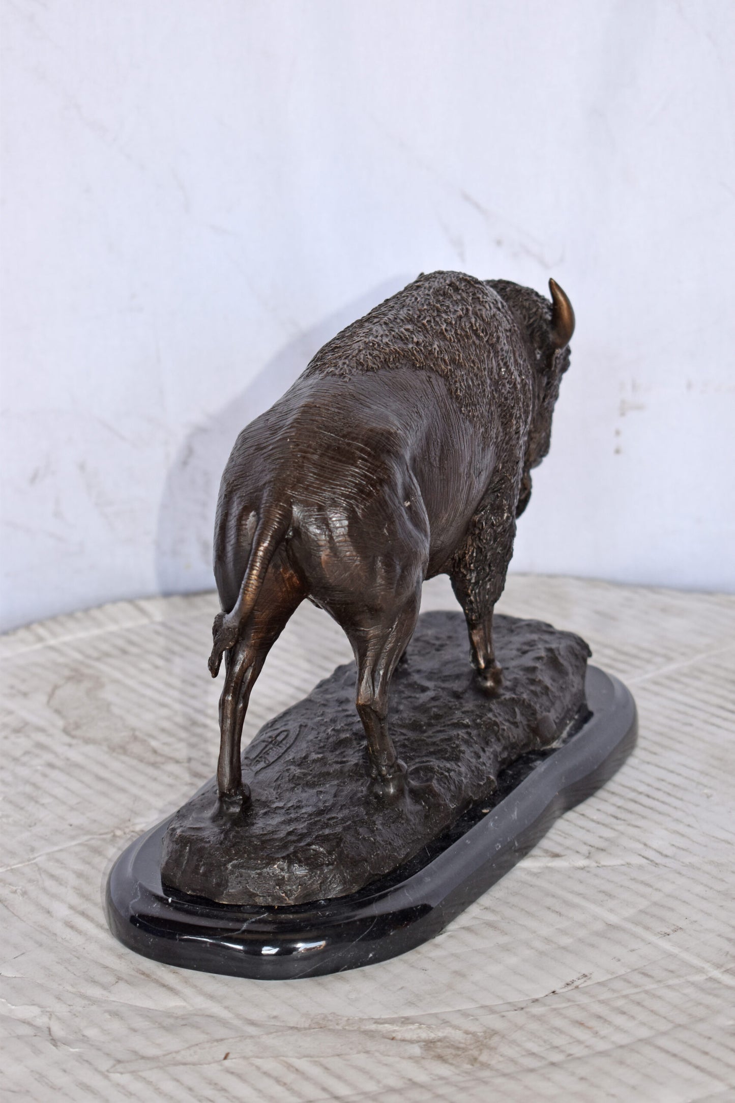 Bison standing and looking down Bronze Statue - Size: 11"L x 6"W x 8"H.