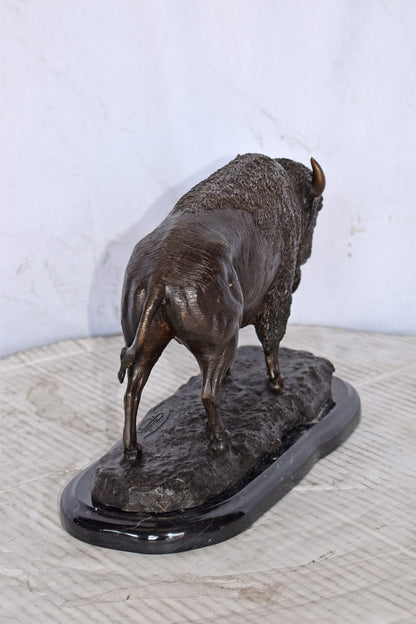 Bison standing and looking down Bronze Statue - Size: 11"L x 6"W x 8"H.